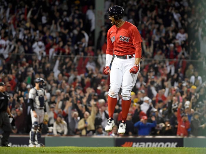 Oct 5, 2021; Boston, Massachusetts, USA; Boston Red Sox shortstop Xander Bogaerts (2) reacts after hitting a two run home run against the New York Yankees during the first inning of the American League Wildcard game at Fenway Park.